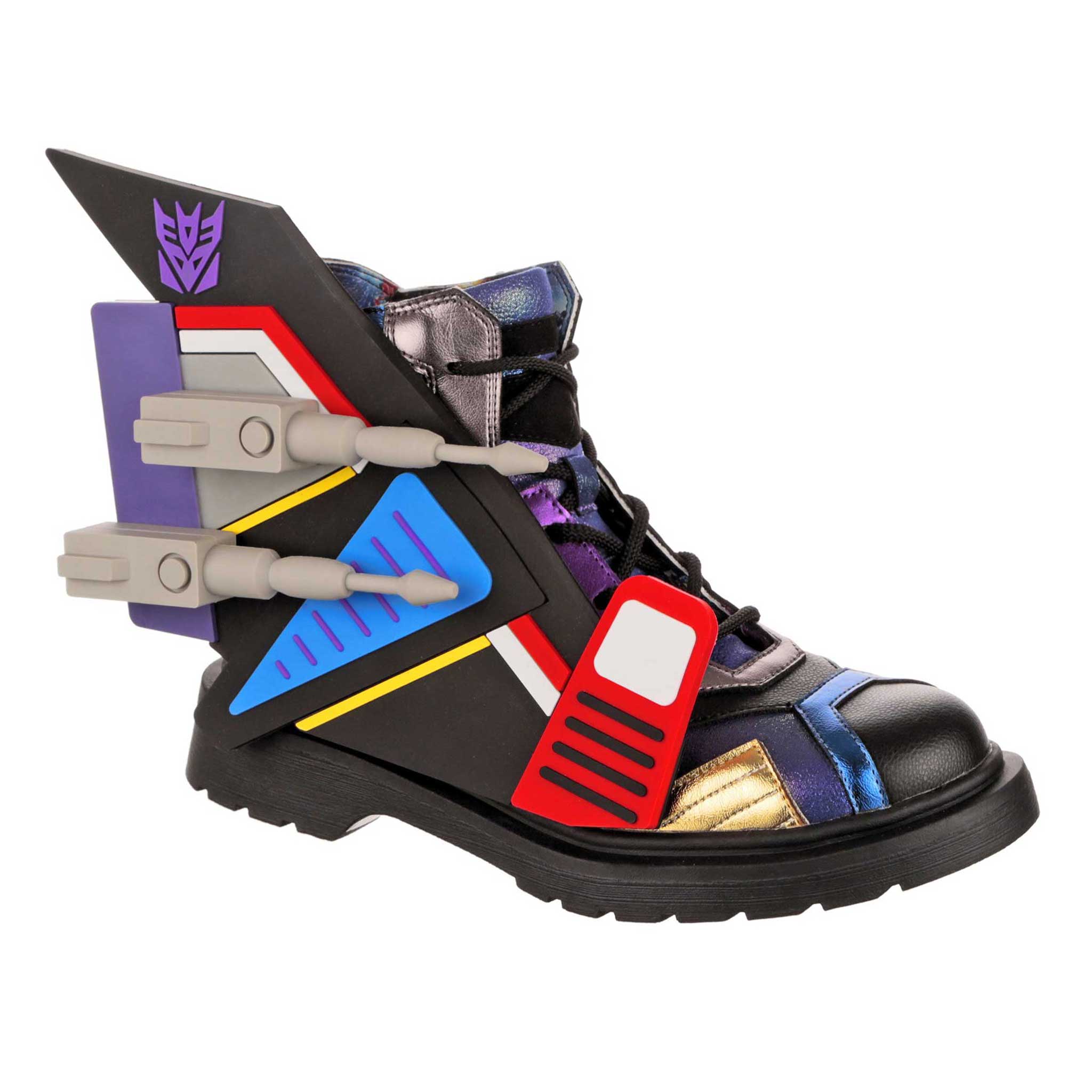 Transformers-themed black lace up ankle boots with black laces, and chunky black details. Removable grey jet wings sit on the side of the lace-up boots. A purple Decepticon logo sit on the side of the black ankle boots, finished off with a white chunky sole.