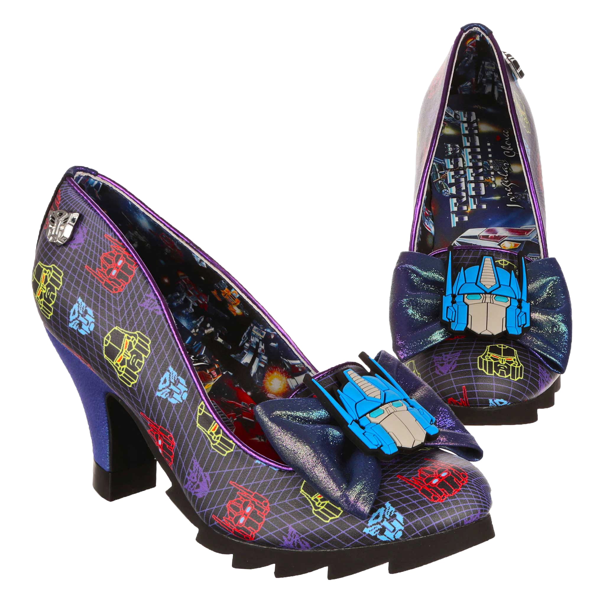 Black and purple Transformers themed high heel shoes with black chunky tread soles and a purple metallic rainbow high heel. Optimus Prime sits on the centre of a matching purple metallic bow on the toe of the shoe, whilst Autobot and Decepticon logos make up the geometric print of the shoe. A classic comic strip style print of a Transformers battle scene makes up the lining of the shoe with a Transformers X Irregular Choice logo.