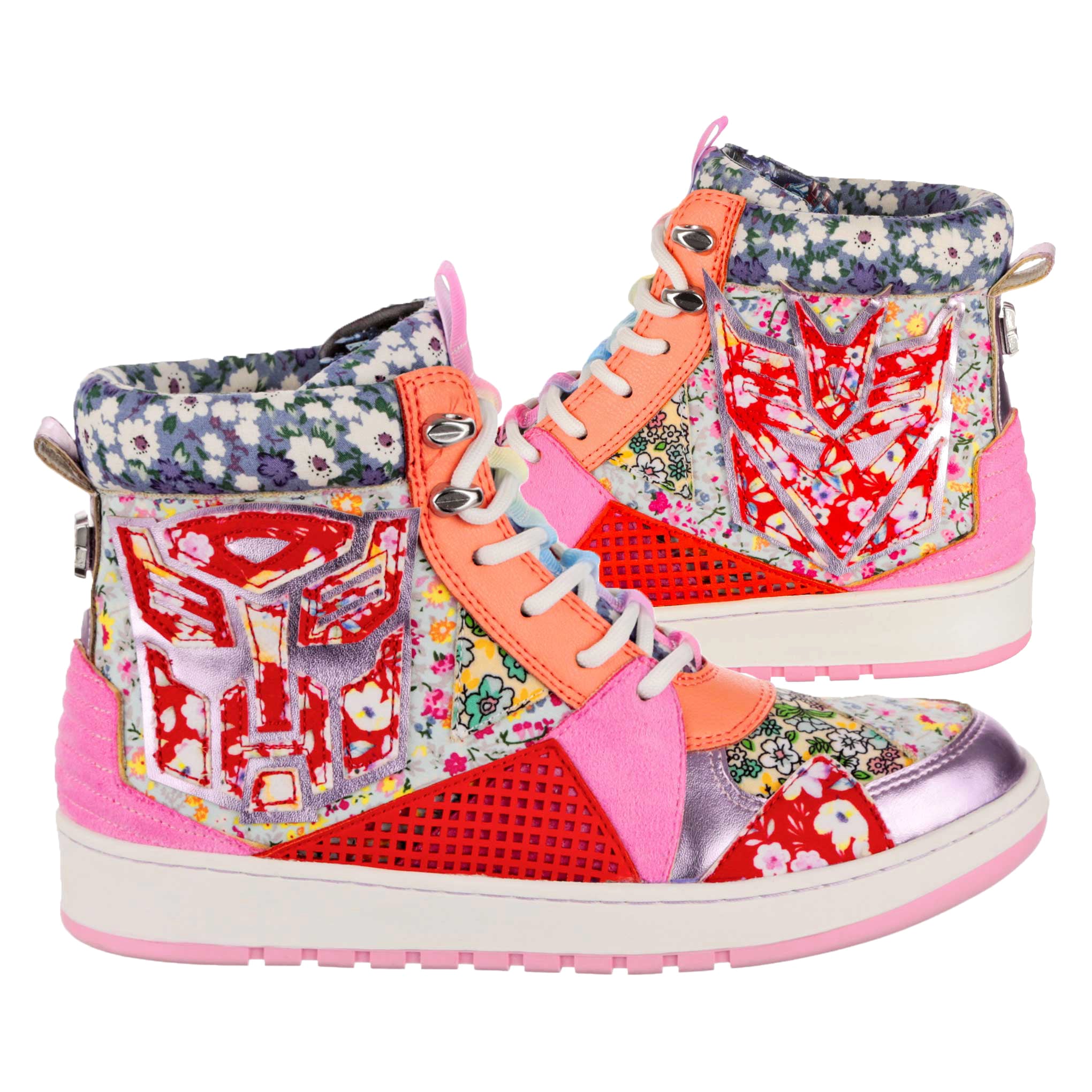 A pair of lace-up Transformers inspired high top trainers sit side by side. Multicoloured retro floral prints are mixed with red, pink and orange details as well as a red embroidered Decepticon and Autobot logo on each boot. A white and pink chunky sole matches the white laces while a silver pull up tab sits at the back of the ankle boot. 