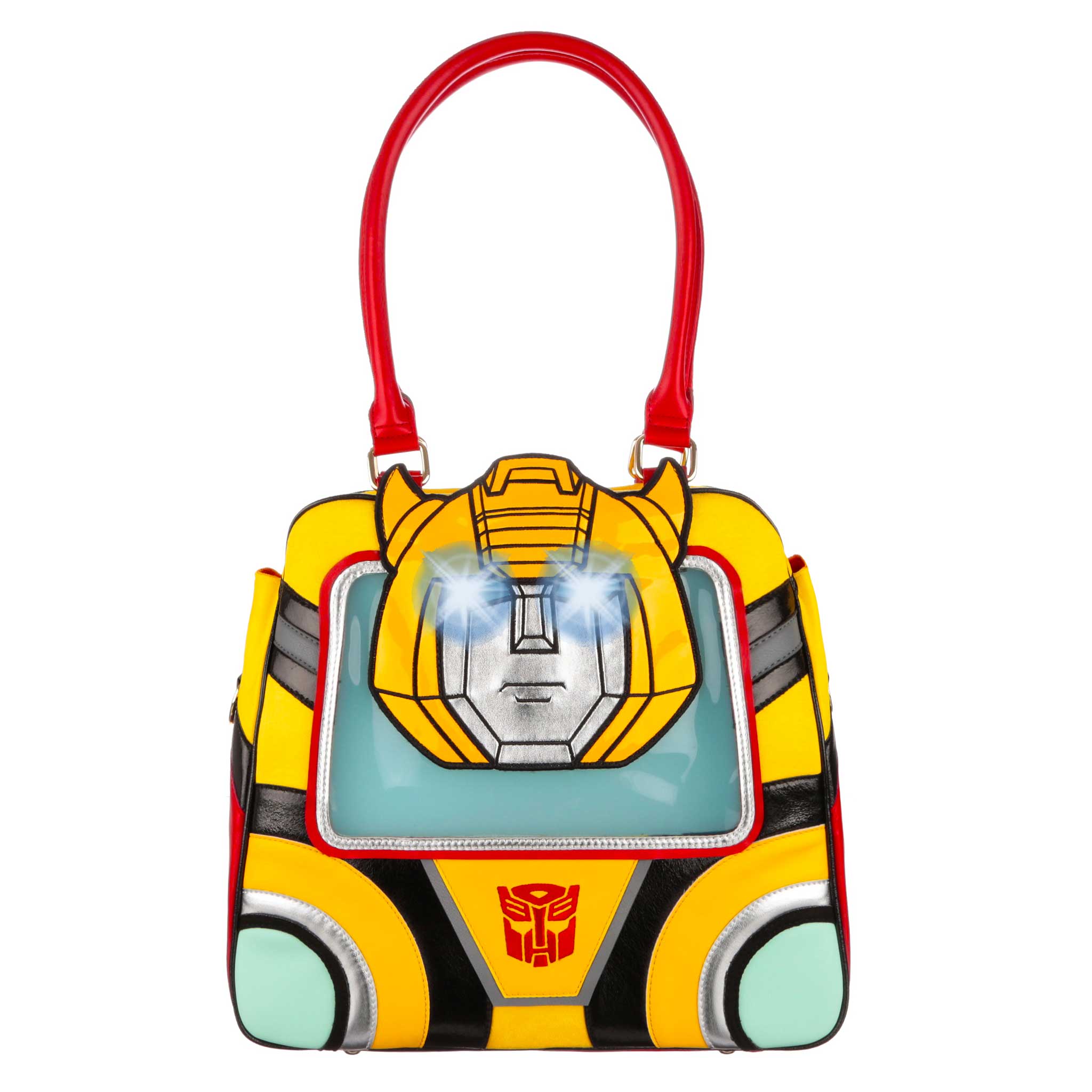 A large yellow Transformers themed handbag with a large red handle that sits at the top of the bag. A big holdall made up of bold black and yellow stripes with a red Decepticon logo at the bottom of the bag. The face of Decepticon Transformer Bumblebee sits on the front of the bag with large flashing eyes. Red and black piping finish off this large handbag. 